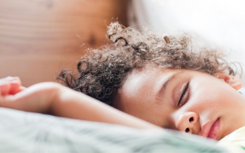 a drowsy little boy rests on a pillow